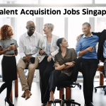 Diverse group of professionals standing and sitting together together, symbolizing the collaborative nature of talent acquisition jobs Singapore. Text overlay: Top 10 Talent Acquisition Jobs Singapore [2024].